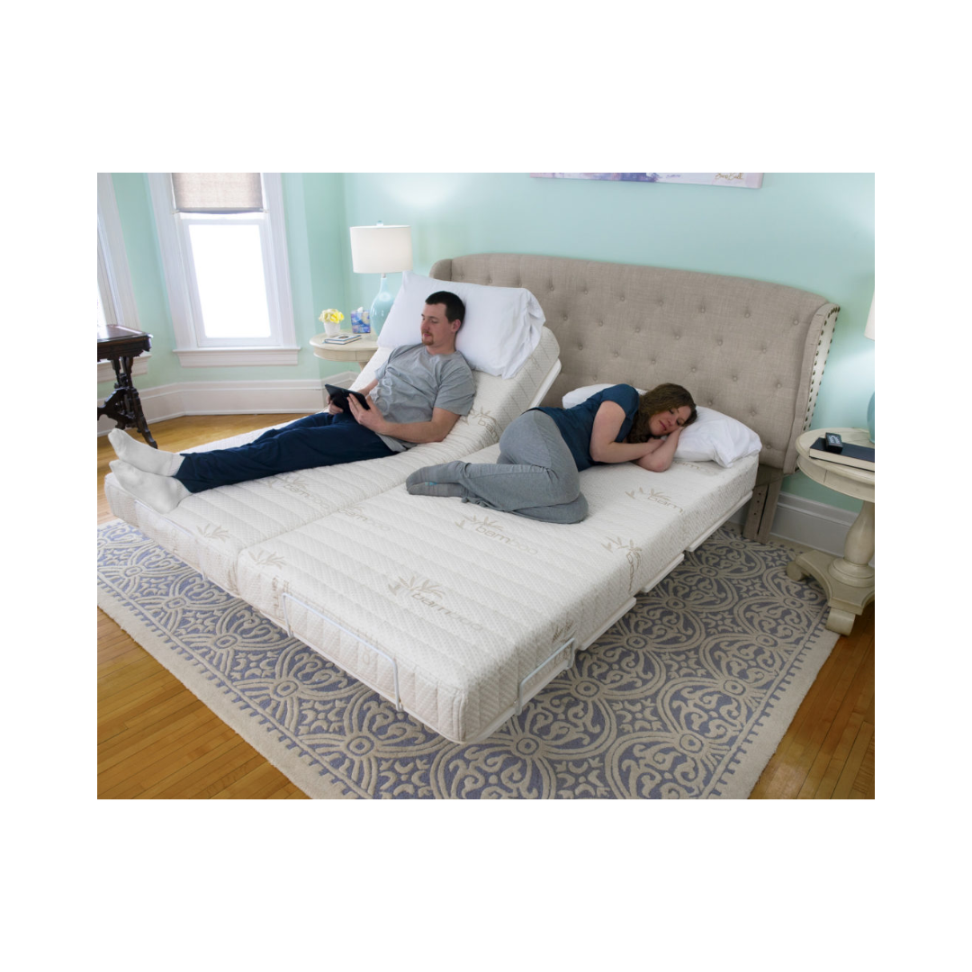 Adjustable split bed with couple resting and beige tufted headboard in cozy bedroom