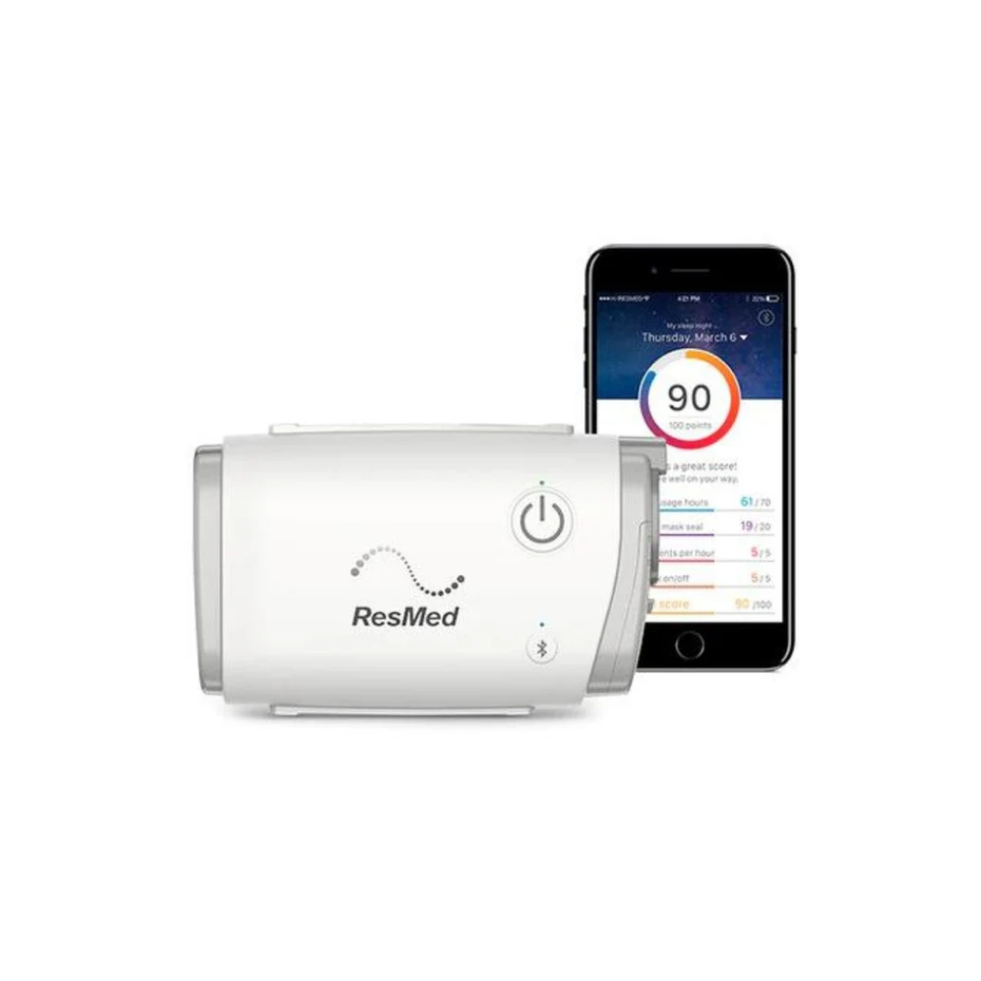 ResMed AirMini AutoSet Portable CPAP device next to smartphone showing sleep data app