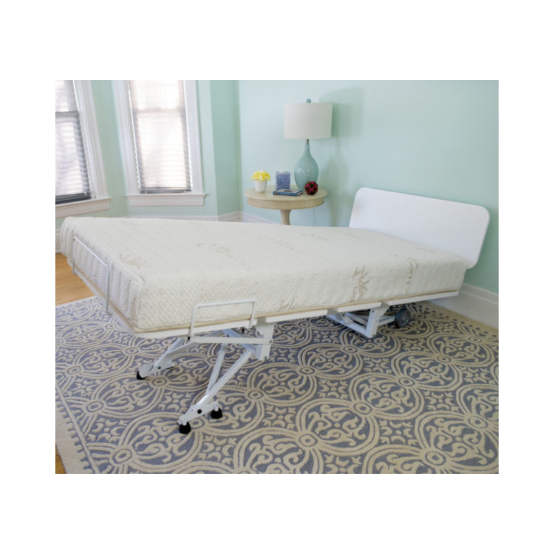 Transfer Master New Valiant Adjustable Hospital Bed with white frame and mattress in a light blue room