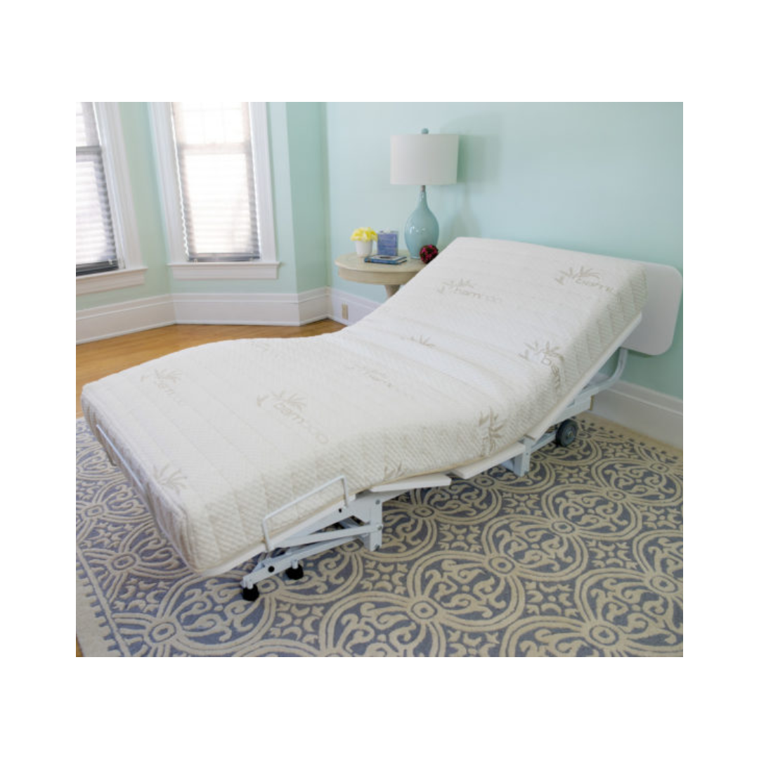 Transfer Master New Valiant Adjustable Hospital Bed with white mattress in a light blue room